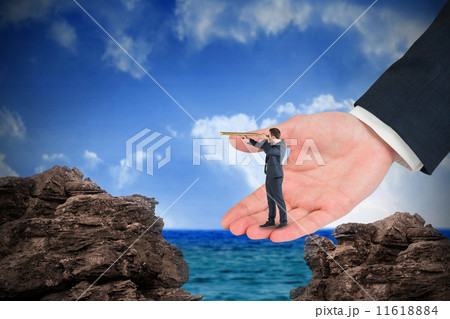 Composite image of businessman looking through telescope in larg 11618884