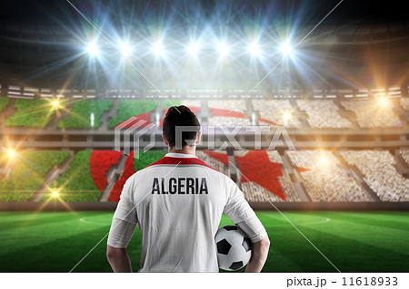 Composite image of algeria football player holding ball Composite image of algeria football player holding ball 11618933