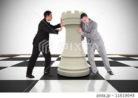 Composite image of business people pushing chess piece Composite image of business people pushing chess piece 11619048