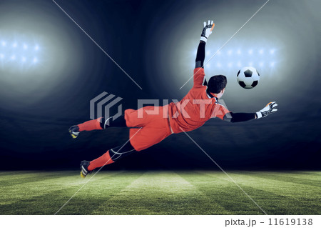 Composite image of fit goal keeper jumping up 11619138