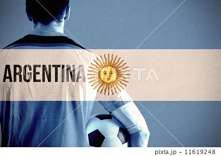 Composite image of argentina football player holding ball 11619248