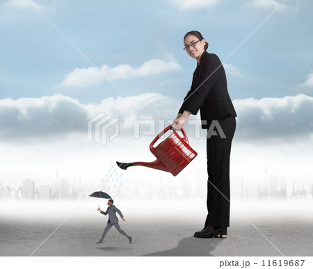Composite image of businesswoman watering tiny business man 11619687