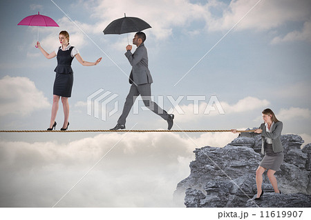 Young businesswoman pulling a tightrope for business people 11619907