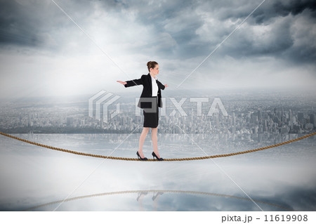 Composite image of businesswoman performing a balancing act on t 11619908