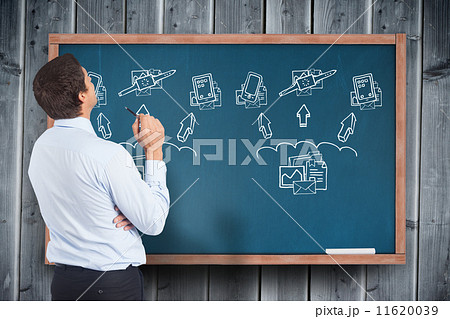 Composite image of thinking businessman holding pen 11620039