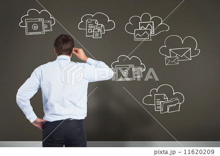 Composite image of thinking businessman tilting glasses 11620209