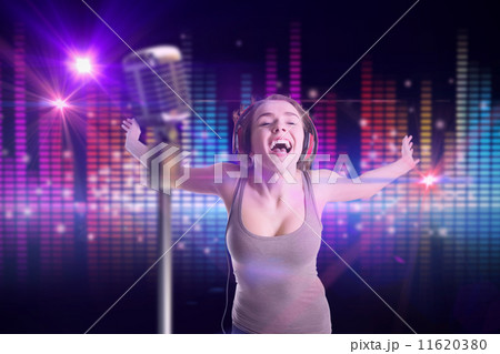 Composite image of pretty girl listening to music 11620380