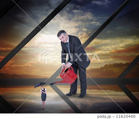 Composite image of mature businessman watering tiny businesswoma 11620400