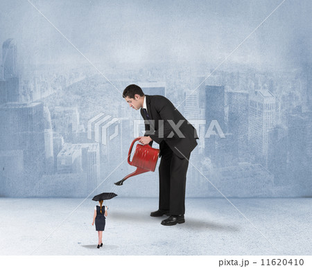 Composite image of businessman watering tiny businesswoman Composite image of businessman watering tiny businesswoman 11620410