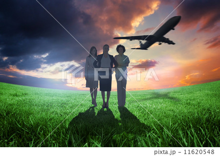 Composite image of team of businesswomen looking at camera with Composite image of team of businesswomen looking at camera with 11620548
