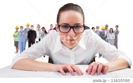 Composite image of businesswoman typing on a keyboard 11620580