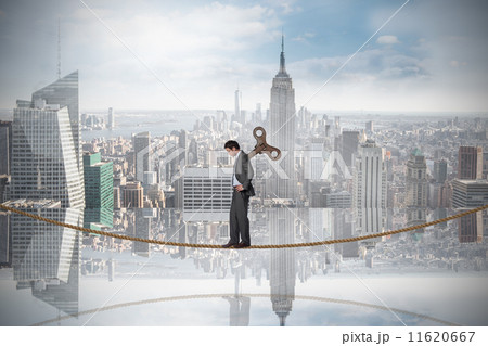 Composite image of wound up businessman with hands on hips on ti Composite image of wound up businessman with hands on hips on ti 11620667