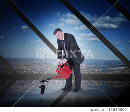 Composite image of mature businessman watering tiny businesswoma 11620869