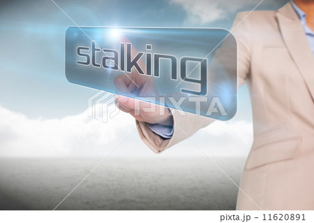 Businesswoman pointing to word stalking Businesswoman pointing to word stalking 11620891