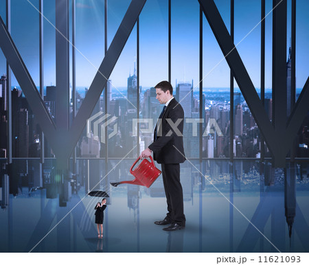 Composite image of businessman watering tiny businesswoman 11621093