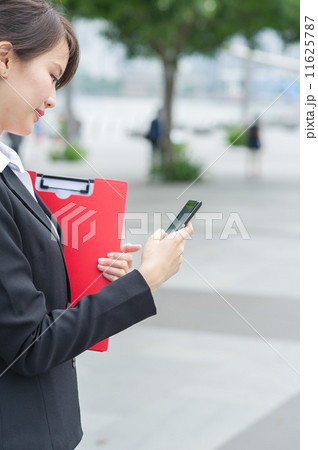A young female Insurance Agent is making call on her mobile phone A young female Insurance Agent is making call on her mobile phone 11625787