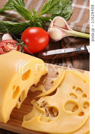 Cheese on a cutting board, basil, tomato Cheese on a cutting board, basil, tomato 11626408