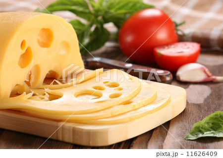 Cheese on a cutting board, basil, tomato 11626409