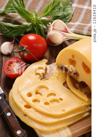 Cheese on a cutting board, basil, tomato Cheese on a cutting board, basil, tomato 11626410