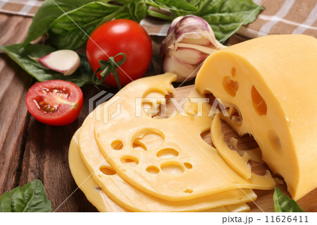 Cheese on a cutting board, basil, tomato Cheese on a cutting board, basil, tomato 11626411