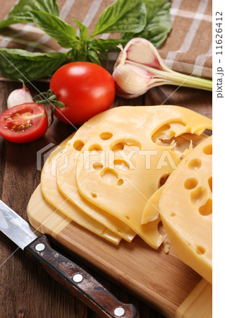 Cheese on a cutting board, basil, tomato Cheese on a cutting board, basil, tomato 11626412
