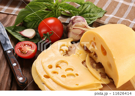 Cheese on a cutting board, basil, tomato Cheese on a cutting board, basil, tomato 11626414
