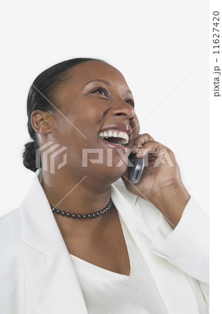 Studio shot of African woman on her cell phone  11627420