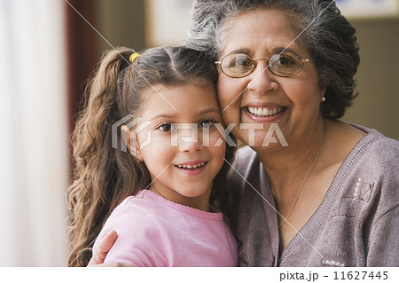 Hispanic grandmother hugging granddaughter Hispanic grandmother hugging granddaughter 11627445