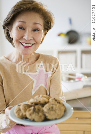Japanese woman holding plate of cookies Japanese woman holding plate of cookies 11627451