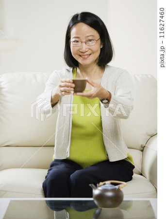 Asian woman drinking tea Asian woman drinking tea 11627460
