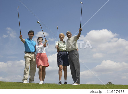 Multi-ethnic couples holding golf clubs 11627473