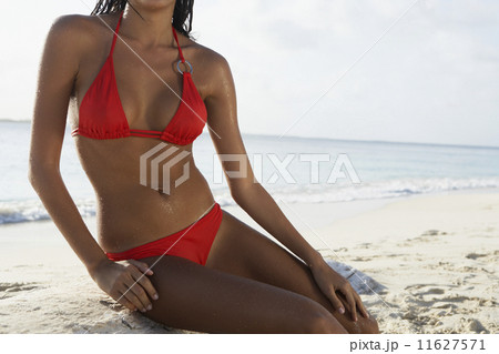 South American woman sitting on beach South American woman sitting on beach 11627571