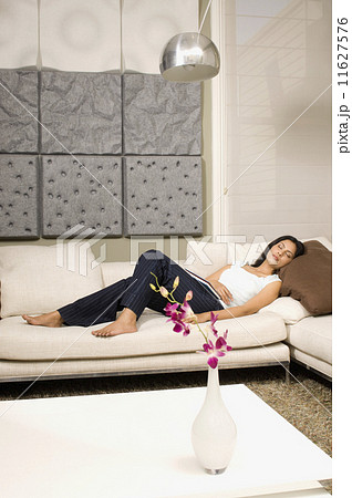 Indian woman sleeping on sofa 11627576