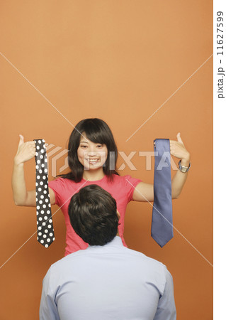 Woman helping man select tie 11627599