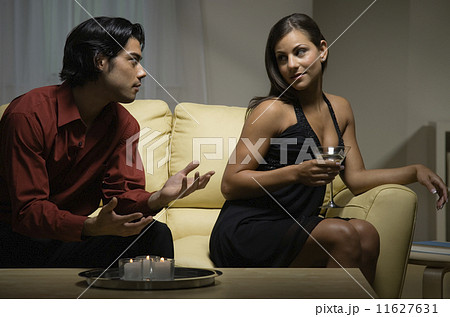 Woman looking over shoulder at boyfriend 11627631