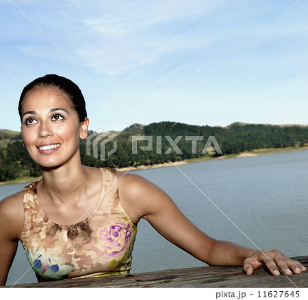 Hispanic woman with water in background 11627645
