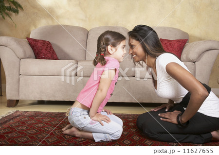 Indian mother and daughter smiling at each other 11627655