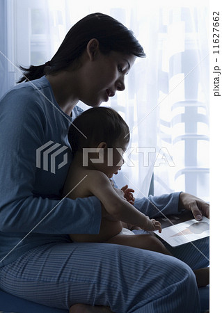 Mother reading to baby Mother reading to baby 11627662