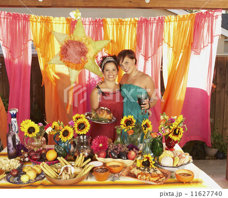 Mother and daughter behind buffet table Mother and daughter behind buffet table 11627740