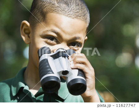 Mixed Race boy holding binoculars 11627747
