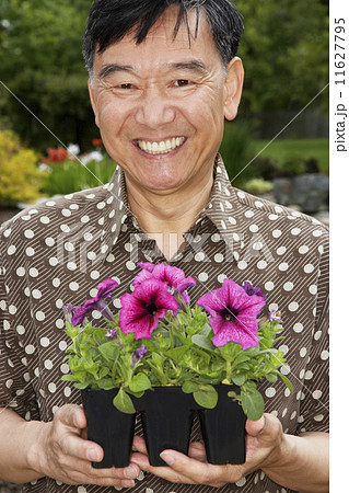 Senior Asian man holding potted plants Senior Asian man holding potted plants 11627795