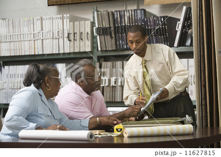 African American couple looking at flooring samples 11627815
