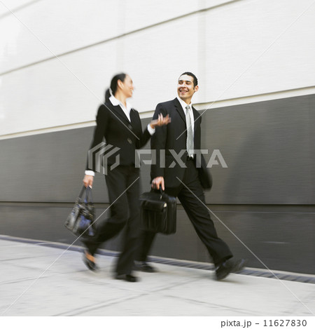 Hispanic businesspeople walking 11627830