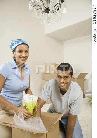 Indian couple unpacking moving boxes 11627857