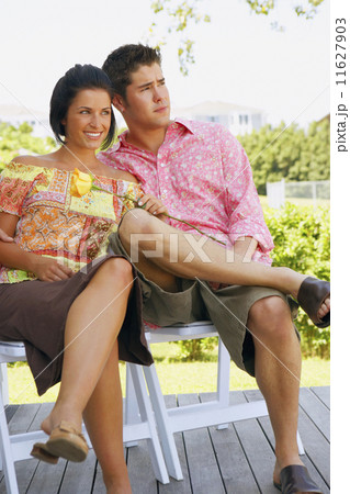 Young couple sitting outdoors 11627903