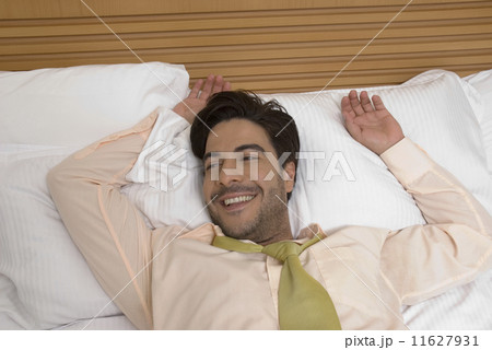 Hispanic businessman laying in bed 11627931