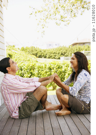 Couple holding hands on deck 11628010