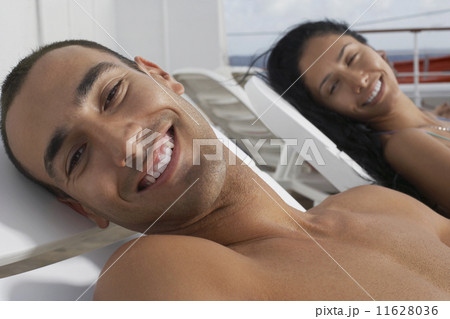 Hispanic couple sunbathing 11628036