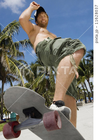 Hispanic man riding skateboard 11628037