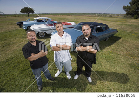 Hispanic men in front of low rider cars Hispanic men in front of low rider cars 11628059